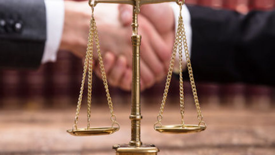 Close-up Of Justice Scale On Wooden Desk
